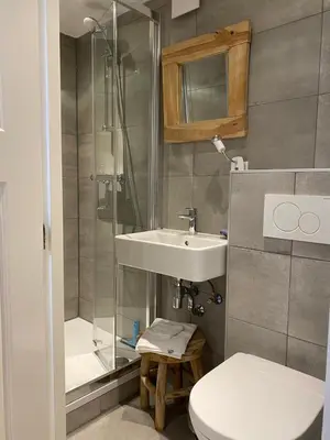 a bathroom with a sink and a toilet and a shower at Studio Lief Bergen binnen, bij bos duin en dorp in Bergen