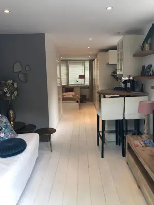 a living room with a kitchen and a dining room at Studio Lief Bergen binnen, bij bos duin en dorp in Bergen