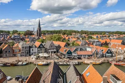 an aerial view of a town with boats in the water at The Dutch Buoy in Monnickendam