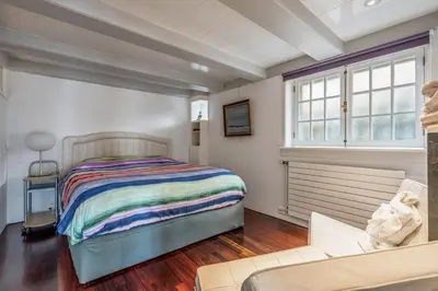 a bedroom with a bed and a couch at The Dutch Buoy in Monnickendam