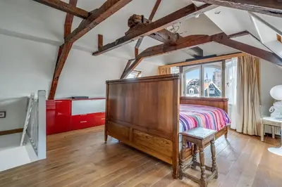 a bedroom with a bed and a window at The Dutch Buoy in Monnickendam