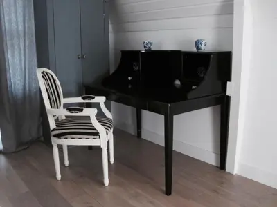 a black desk with a chair and a television at House of Cocagne in Kockengen