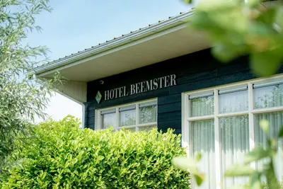 a house with a sign that reads hotel berliner at Hotel Beemster in Middenbeemster