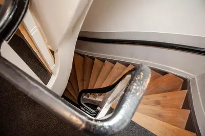a stairwell with a shoe on a wooden floor at Zwanestein Canal House in Amsterdam