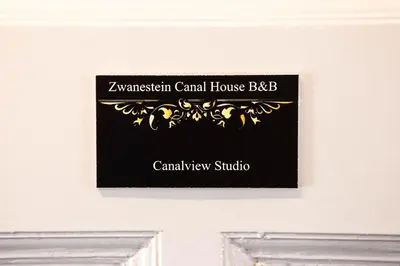 a sign on the door of a room at Zwanestein Canal House in Amsterdam