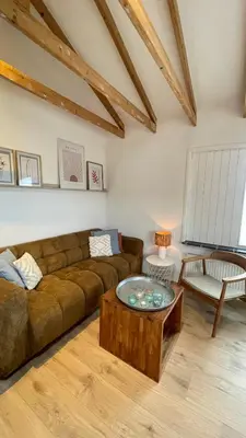 a living room with a couch and a coffee table at Kust 1 in Egmond aan Zee