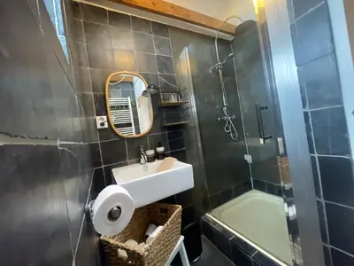 a bathroom with a sink and a shower at Kust 1 in Egmond aan Zee