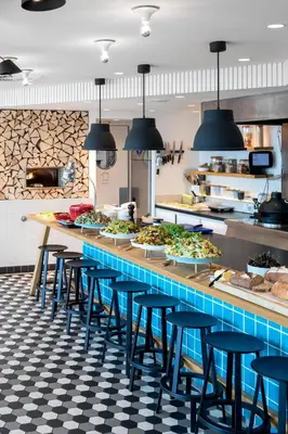 a kitchen with a counter filled with lots of food at Zoku Amsterdam in Amsterdam