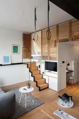 a living room with a staircase leading to a bedroom at Zoku Amsterdam in Amsterdam