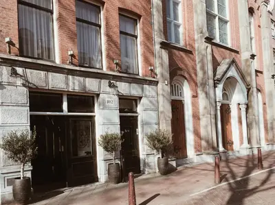 an old brick building with doors and windows at Mr. Jordaan in Amsterdam