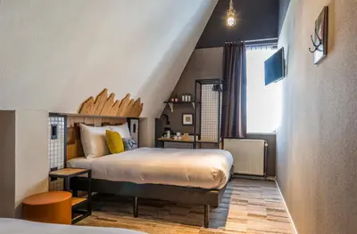 a bedroom with a large bed and a window at Mr. Jordaan in Amsterdam