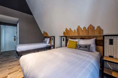 a bedroom with a large white bed with a headboard at Mr. Jordaan in Amsterdam