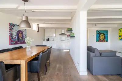 a dining room and living room with a table and chairs at Amsterdam Centre Harbour Apartments in Amsterdam