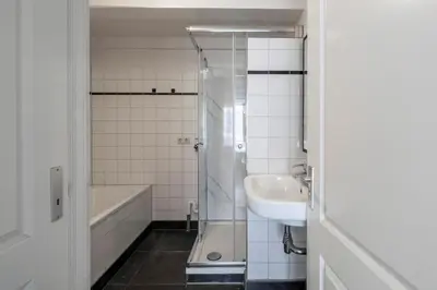 a bathroom with a shower and a sink and a tub at Amsterdam Centre Harbour Apartments in Amsterdam