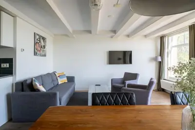 a living room with couches and a table at Amsterdam Centre Harbour Apartments in Amsterdam