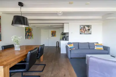 a living room with a table and a couch at Amsterdam Centre Harbour Apartments in Amsterdam