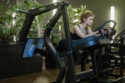 a woman sitting on a treadmill in a gym at Hotel & Wellness Zuiver in Amsterdam