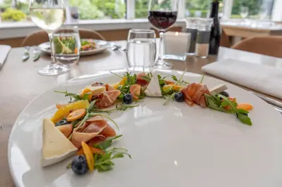a white plate with food on a table at Fletcher Hotel Restaurant De Witte Raaf in Noordwijk