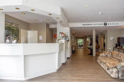 a lobby with couches and a counter in a store at Fletcher Hotel Restaurant De Witte Raaf in Noordwijk