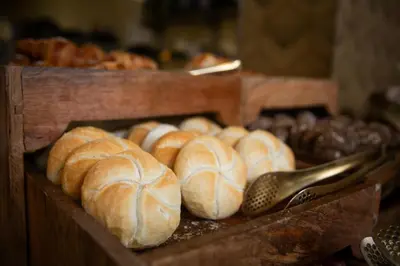 a bunch of loaves of bread on a table at Fletcher Hotel Restaurant De Witte Raaf in Noordwijk