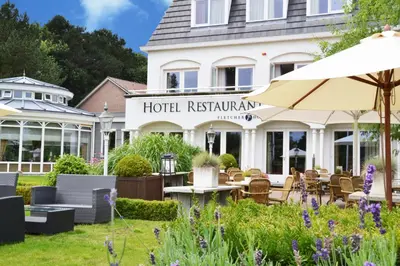 a hotel with a garden and a hotel restaurant at Fletcher Hotel Restaurant De Witte Raaf in Noordwijk