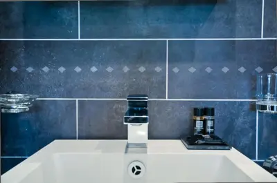 a bathroom with a sink with a bottle on it at B&B La Festa in Amsterdam