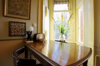 a wooden table in a room with a window at Hotel Museumzicht in Amsterdam