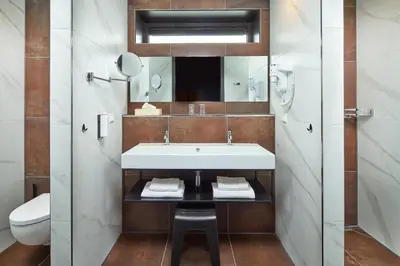 a bathroom with a sink and a toilet at Hotel Babylon Heerhugowaard - Alkmaar in Heerhugowaard