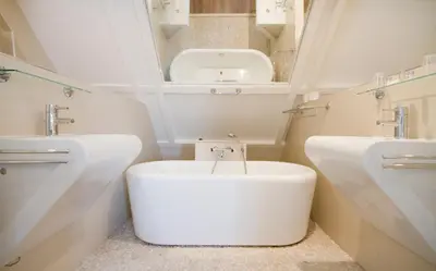 a white bathroom with a toilet and a sink at Acostar Hotel in Amsterdam