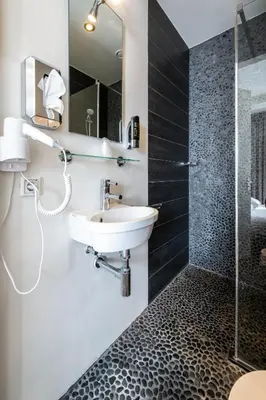 a bathroom with a sink and a shower at Acostar Hotel in Amsterdam