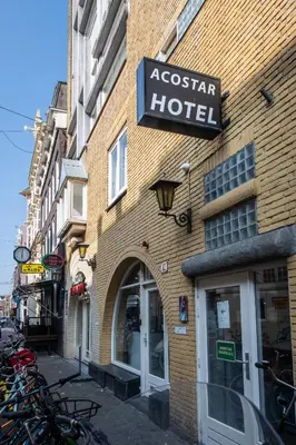 a building with a hotel sign on the side of it at Acostar Hotel in Amsterdam