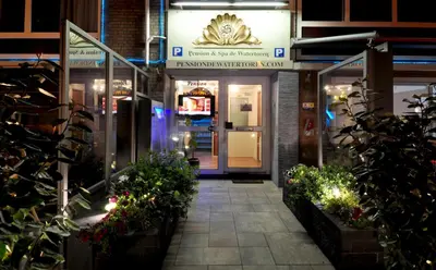 a entrance to a building with plants in front of it at Pension & Spa de Watertoren in Zandvoort