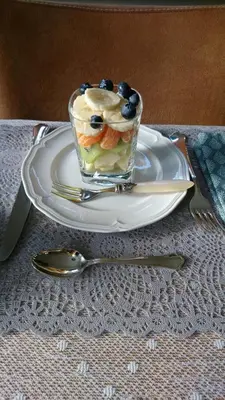 a dessert on a white plate with a fork and spoon at Overbosch in Bilthoven