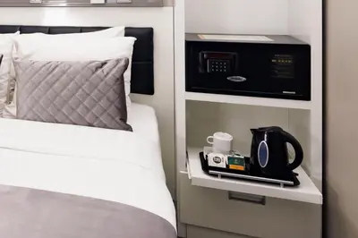 a bedroom with a bed with a microwave and a coffee maker at Hotel CC in Amsterdam