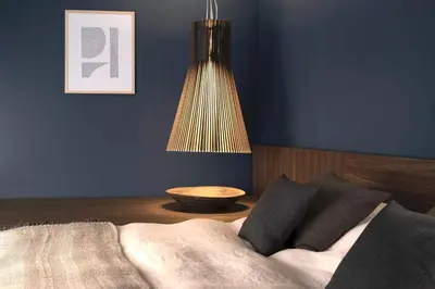a bedroom with blue walls and a bed with pillows at COMMUNE suites in Amsterdam