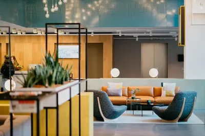 a lobby with a couch and chairs and a table at Hotel Casa Amsterdam in Amsterdam