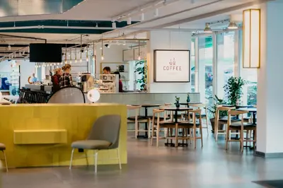 a restaurant with tables and chairs and a counter at Hotel Casa Amsterdam in Amsterdam