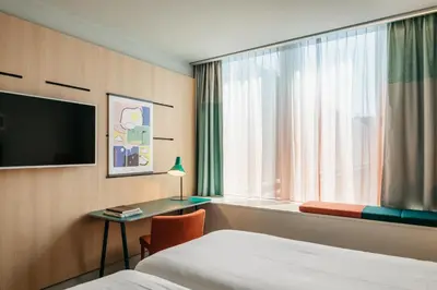 a hotel room with a bed and a window at Hotel Casa Amsterdam in Amsterdam