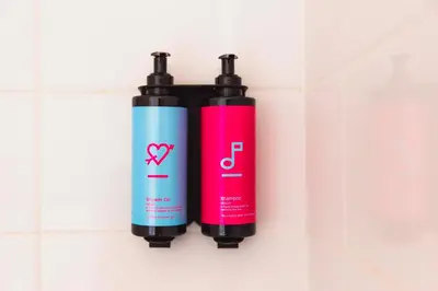 two bottles ofodorizers are hanging on a wall at Hotel Casa Amsterdam in Amsterdam