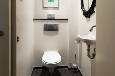 a small bathroom with a toilet and a sink at Marnix360apartments Modern in Amsterdam