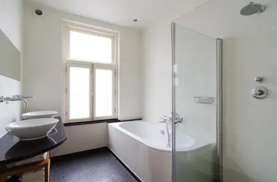 a bathroom with a tub and a toilet and a sink at Marnix360apartments Modern in Amsterdam
