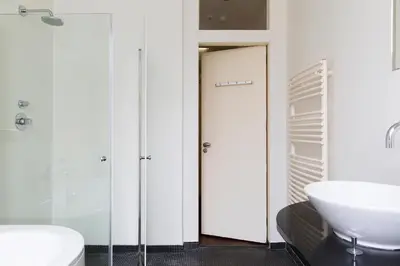 a bathroom with a white toilet and a sink at Marnix360apartments Modern in Amsterdam