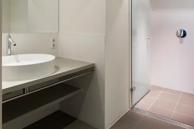 a white bathroom with a sink and a shower at Marnix360apartments Design in Amsterdam