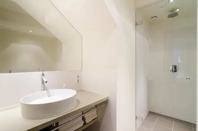 a white bathroom with a sink and a shower at Marnix360apartments Design in Amsterdam
