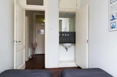 a small hallway with a sink and a mirror at Marnix360apartments Classic in Amsterdam