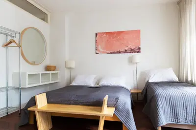 a bedroom with a bed and a table and a mirror at Marnix360apartments Classic in Amsterdam