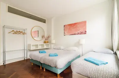a bedroom with two beds and a mirror at Marnix360apartments Classic in Amsterdam