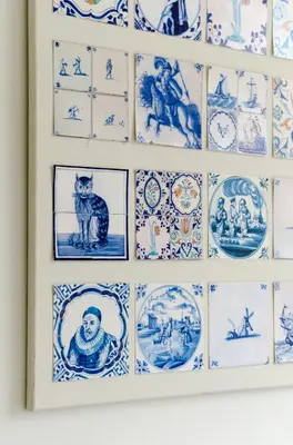 a wall of blue and white plates on a wall at Marnix360apartments Classic in Amsterdam