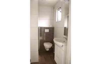 a white bathroom with a toilet and a sink at Awesome Home In Breukelen in Breukelen
