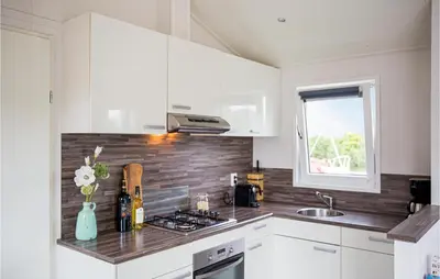 a kitchen with white cabinets and a counter top at Cozy Home In Breukelen With Wifi in Breukelen